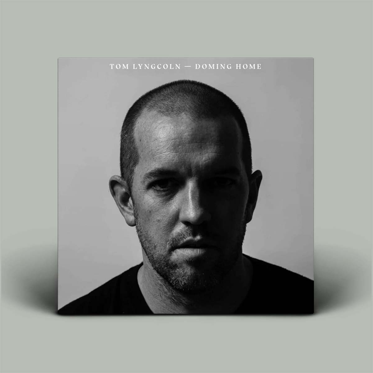 Album cover with a black and white portrait of a man on a gray background