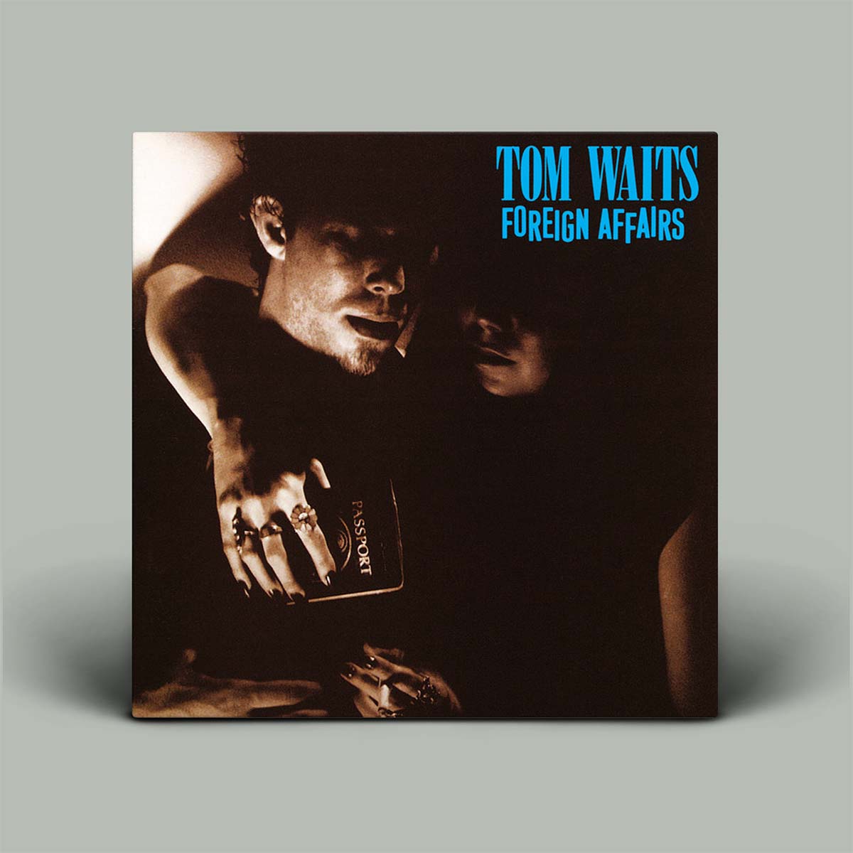 Album cover for 'Foreign Affairs' by Tom Waits with a dark scene and text.