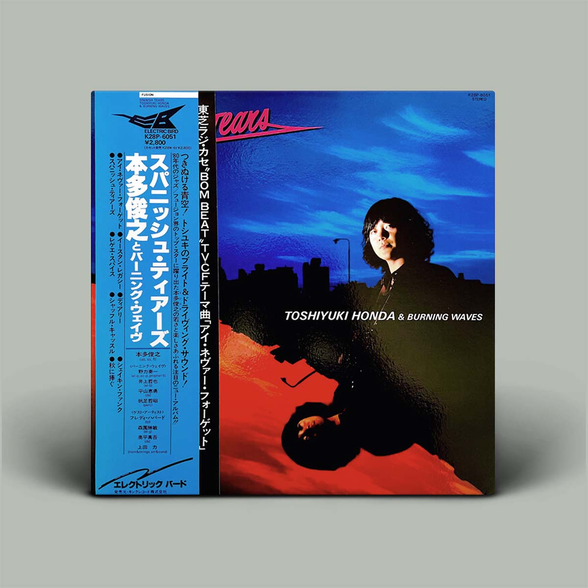 A vinyl record sleeve for Toshiyuki Honda & Burning Waves, featuring a blue and black cover with a portrait of a person and Japanese text on the spine, photographed against a plain gray background.