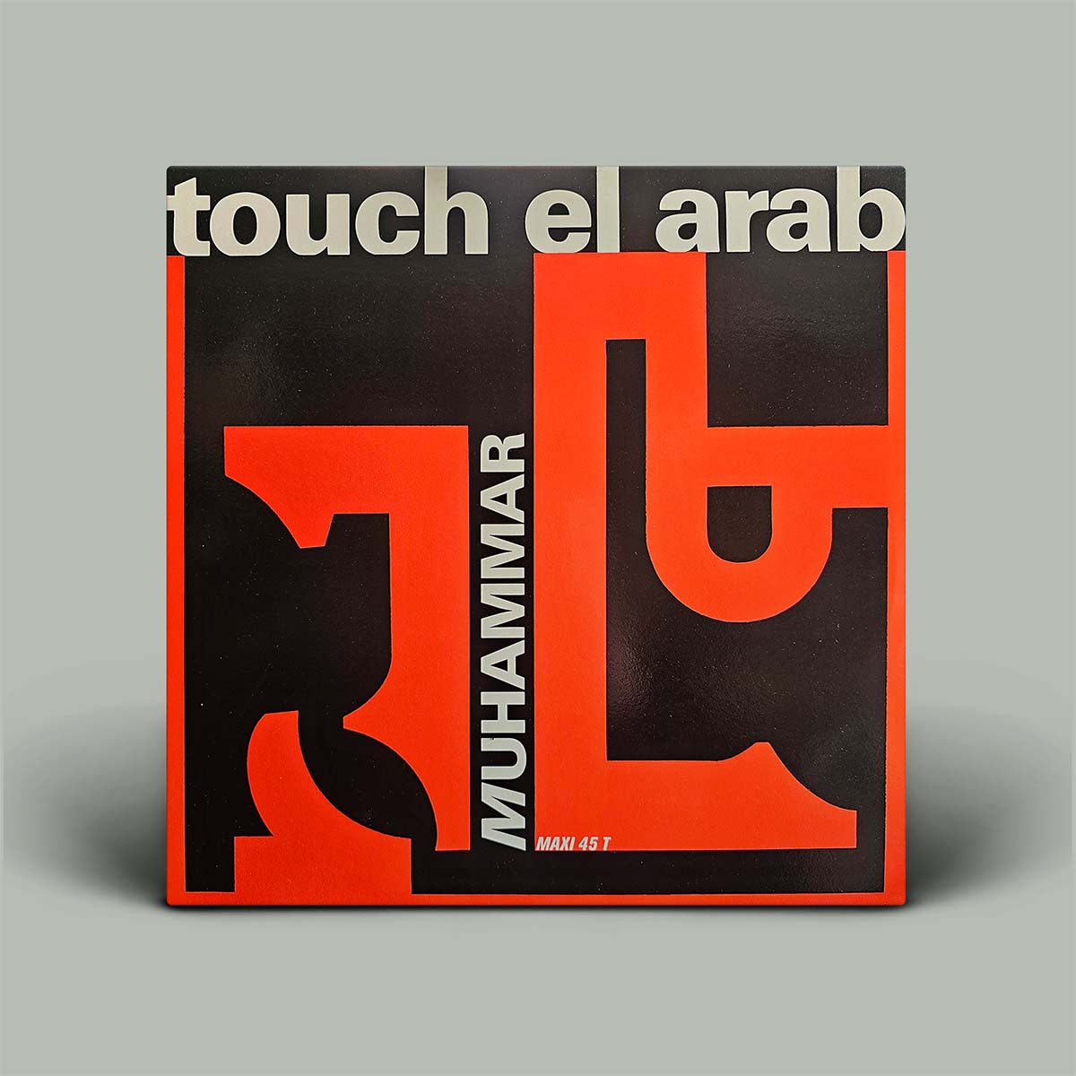 A square vinyl record sleeve for 'touch el arab' featuring a bold graphic design in black and bright red with white text, photographed on a neutral gray background.