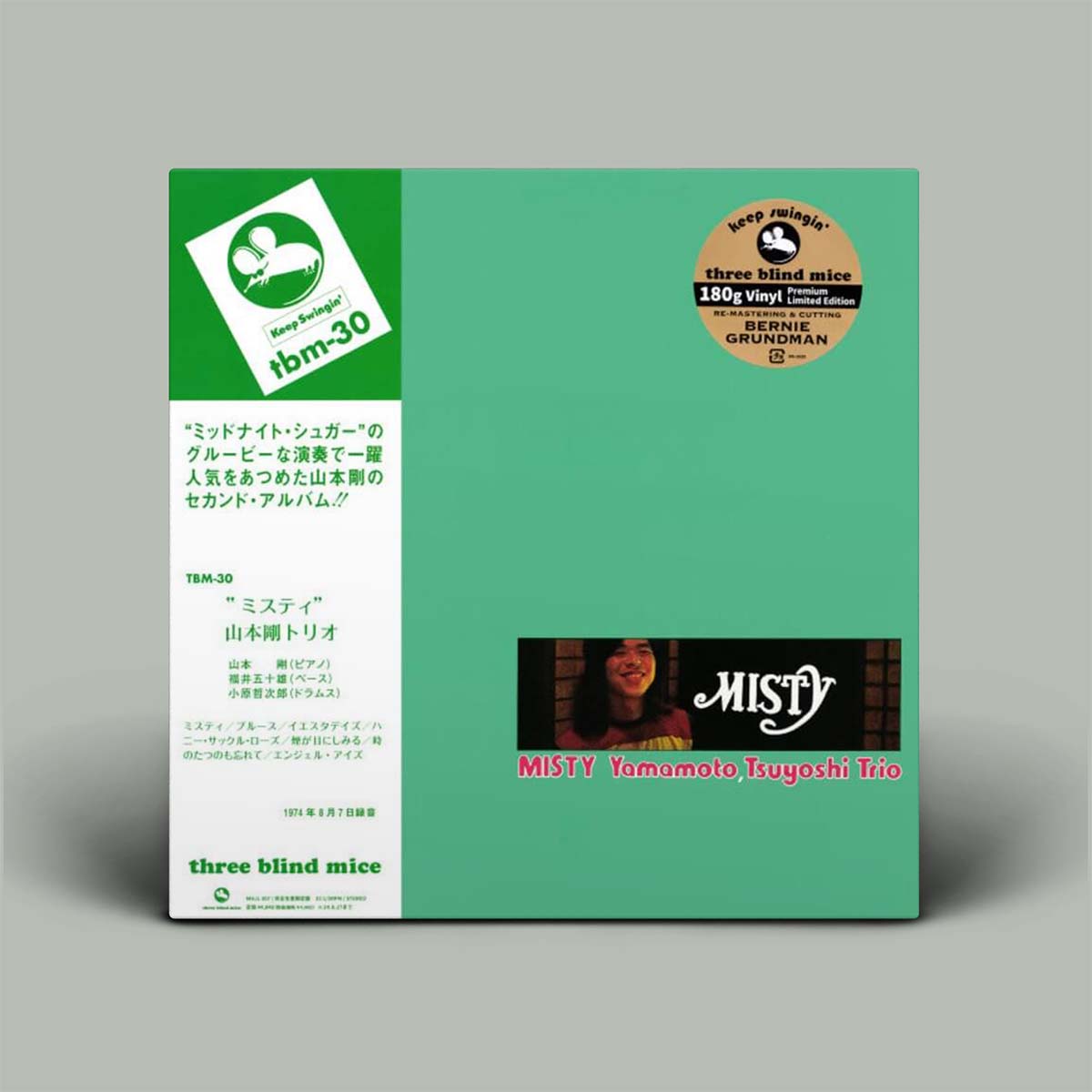 The image shows the album cover for "Misty" by the Tsuyoshi Yamamoto Trio. The cover has a green background with white and black text, featuring the album title, the band's name, and the label 'three blind mice' and 'TBM'.
