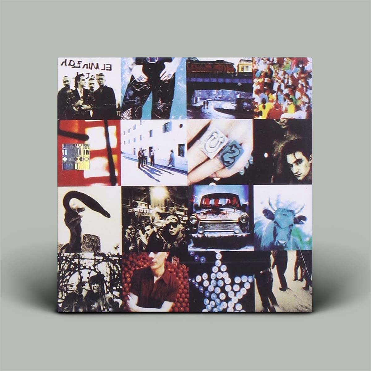 Album cover featuring a 15-panel collage of various artistic photographs, shown standing upright against a solid gray background.