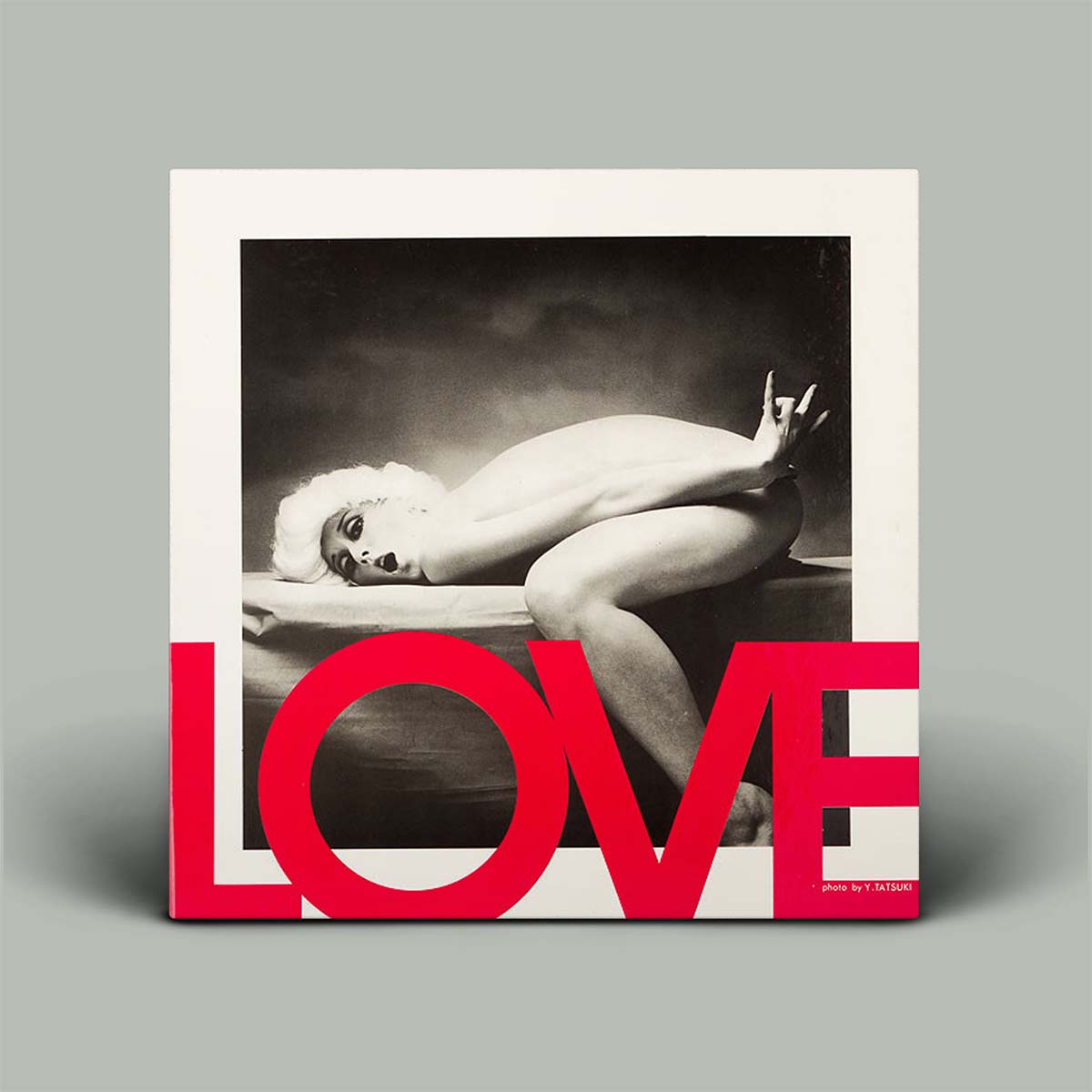 Framed artwork of a nude figure with 'LOVE' text on a gray background