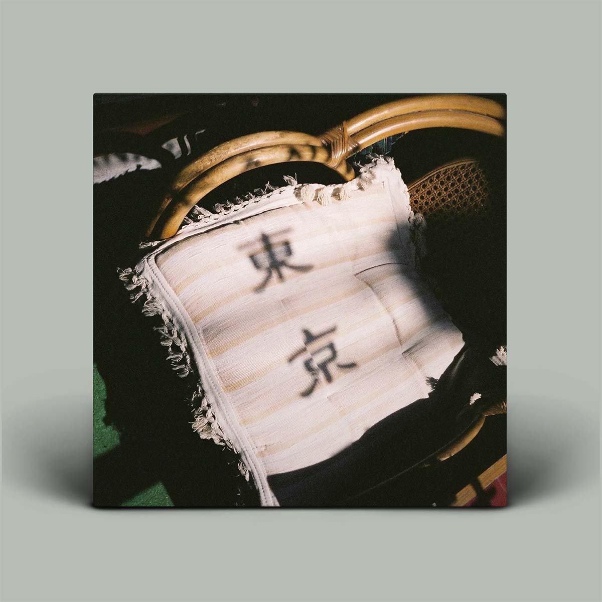 Album cover of a pillow with Japanese kanji letters on it.
