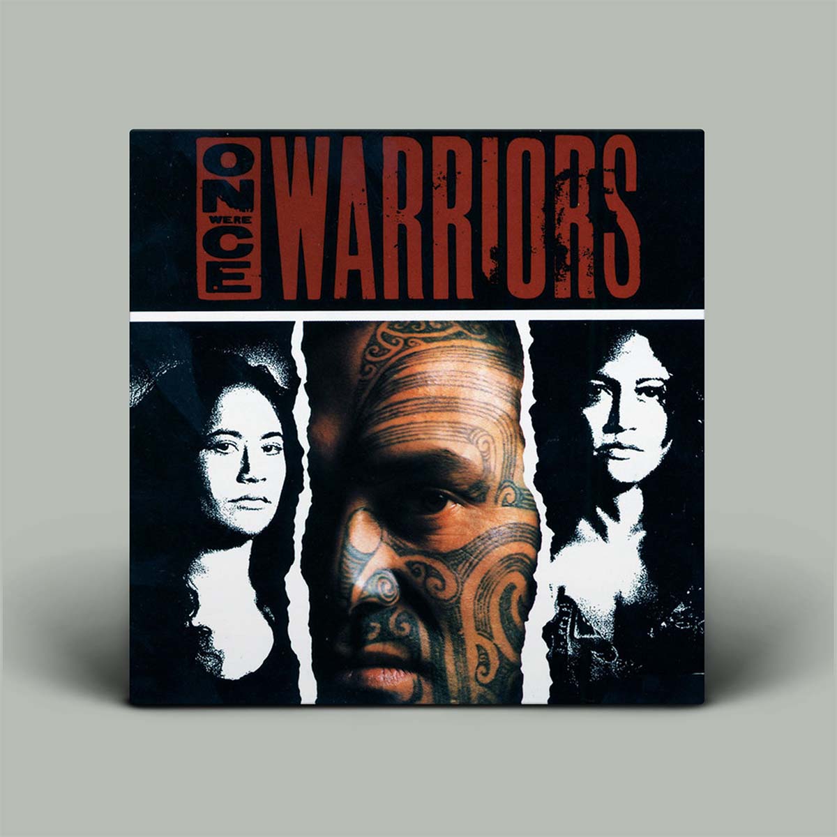 Album cover of 'Once Were Warriors' with three faces and a tattooed face on a gray background