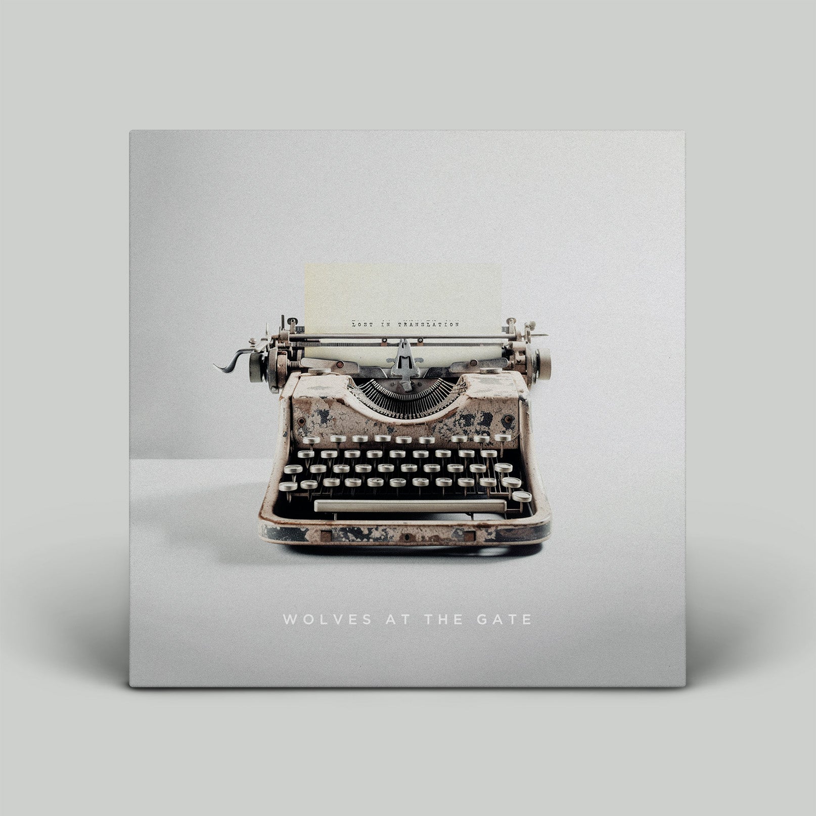 Vintage typewriter on a gray background with 'Wolves at the Gate' text.