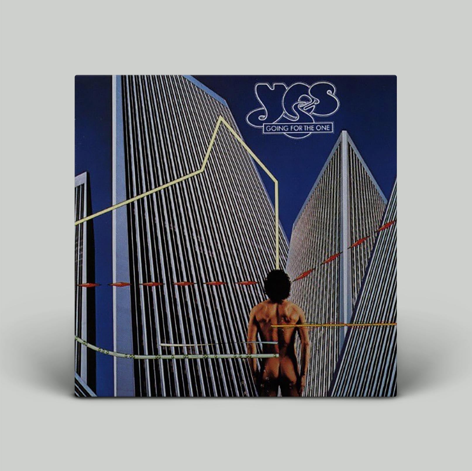 The album cover of 'Going For The One' by YES featuring a person looking towards stylized buildings.